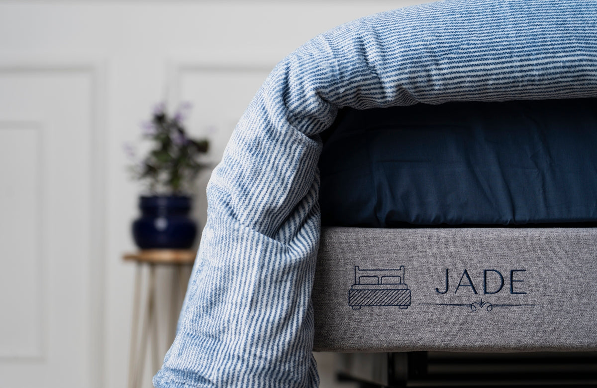a close up of a bed with a name on it