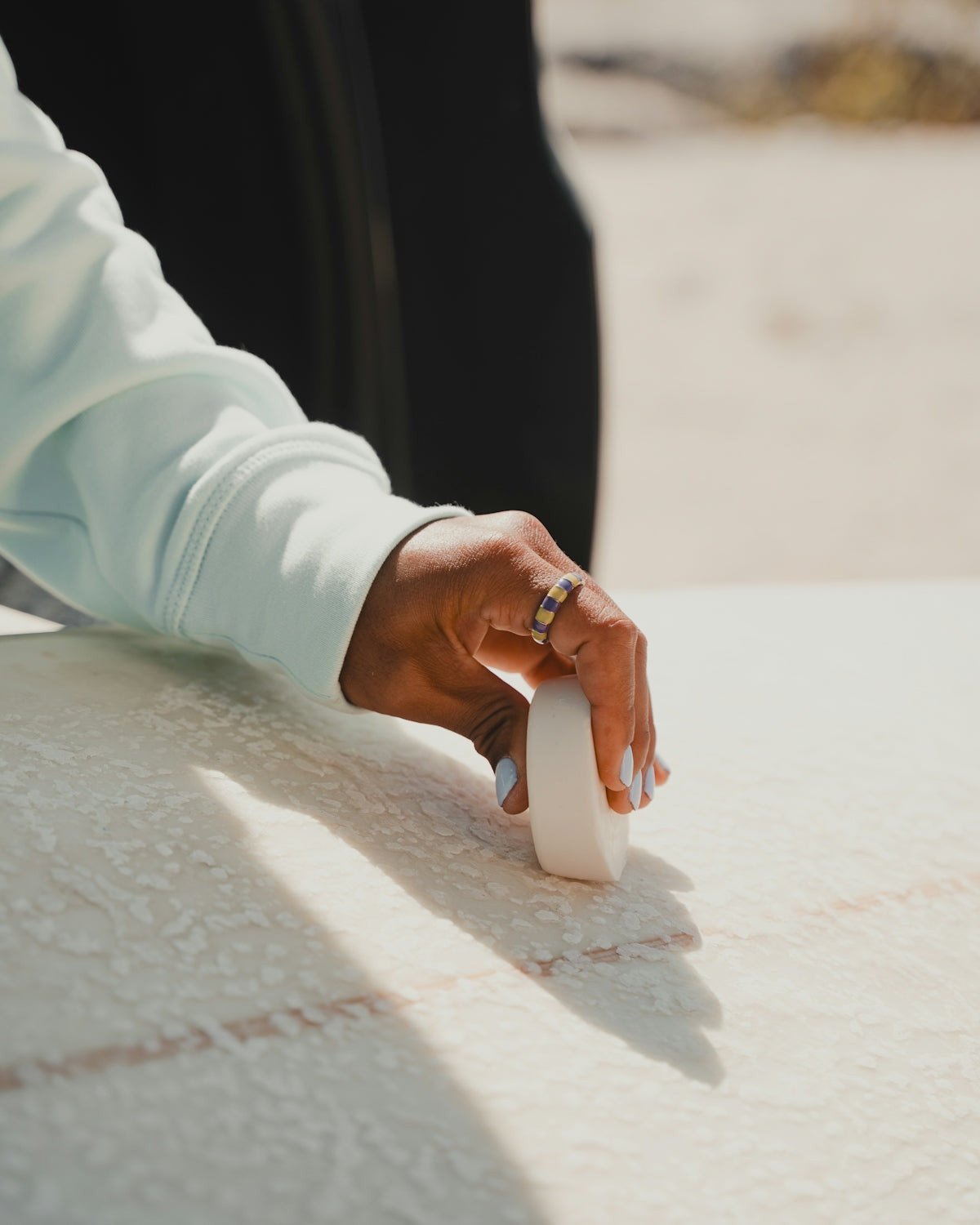 A person holding a white object on top of a table
