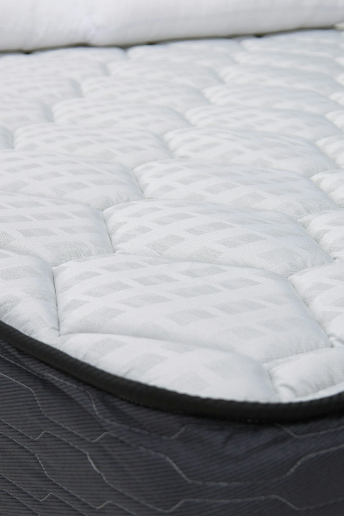 Close-up of a white quilted mattress top